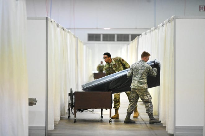The US was totally unprepared for coronavirus despite years of infectious disease warnings. Michigan National Guard members move beds for patients with coronavirus at the TCF Center.