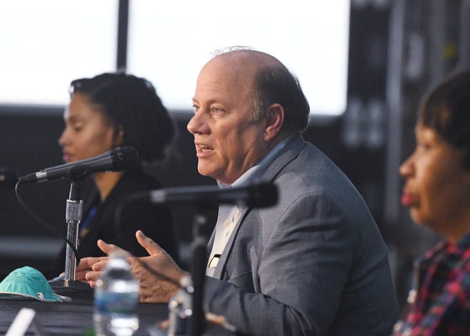 Detroit Mayor Mike Duggan, center, along with Detroit Chief Public Health Officer Denise Fair and Detroit City Council President Brenda Jones, who tested positive for COVID-19 and has since recovered, speak on Detroiters and the coronavirus at a press conference at Shed 5 in Eastern Market in Detroit on April 17, 2020.
