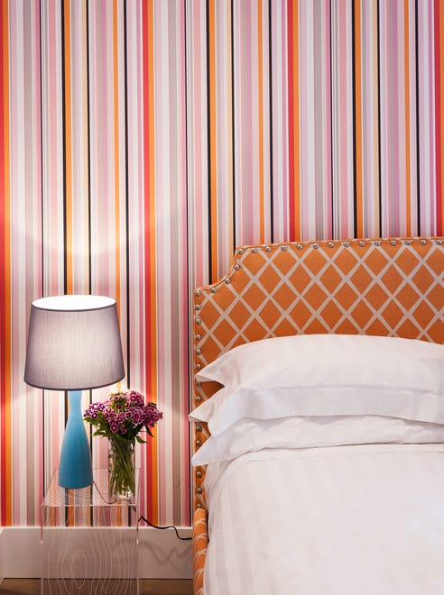 Bedrooms in a project in Seabrook, Washington, were inspired by the designers’ favorite hotel designers and accented with fun wallpaper, custom-made beds, colorful shades and vintage lighting  .