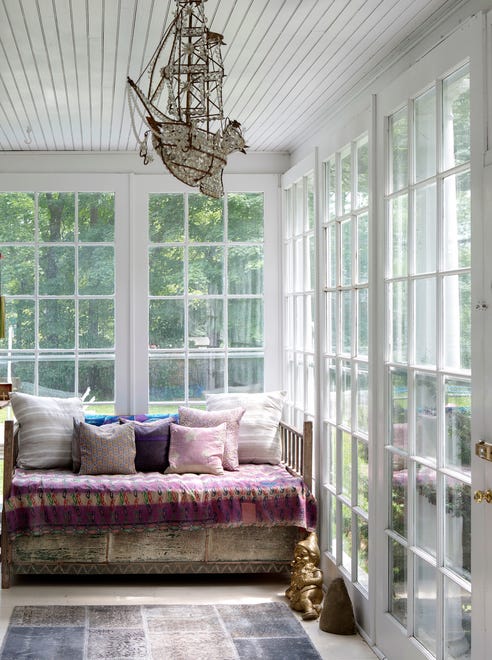 The sun porch at the couple’s second home in Great Barrington, Massachusetts features a ship lamp that they sought for many years and finally found in the back of a lighting store in Texas.