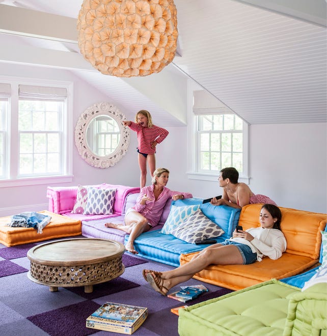 "The media room is our favorite room in the house,” they say of this client’s space, which features a colorful Roche Bobois sectional and a candy bar.