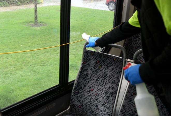 An employee who did not want to be identified disinfects the 17 bus during the stop at Ascension St. John Hospital in Detroit on May 18, 2020. This is the halfway point of the eastbound loop from the State Fair Transit Center and sits here for approximately 30 minutes.  To protect the health and safety of our customers and employees, DDOT is temporarily suspending fare collection for all trips and requesting that customers limit non-essential bus travel until further notice.