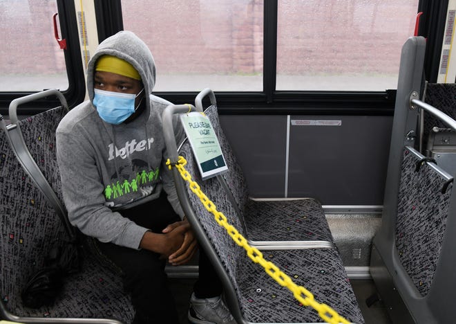 Andre Morris, 17, of Harper Woods rides on bus 17  in Detroit on May 18, 2020. To protect the health and safety of our customers and employees, DDOT is temporarily suspending fare collection for all trips and requesting that customers limit non-essential bus travel until further notice.