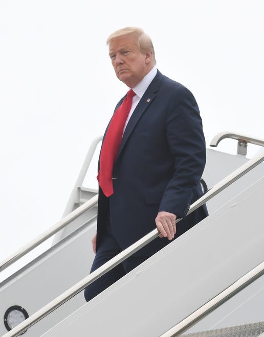 President Donald J. Trump walks down the steps from Air Force One at Detroit Metropolitan Airport in Ypsilanti.