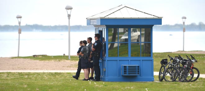 Port Huron police officers and cadets keep an eye on beachgoers.