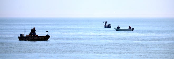 People fish as seen from Lighthouse Beach.