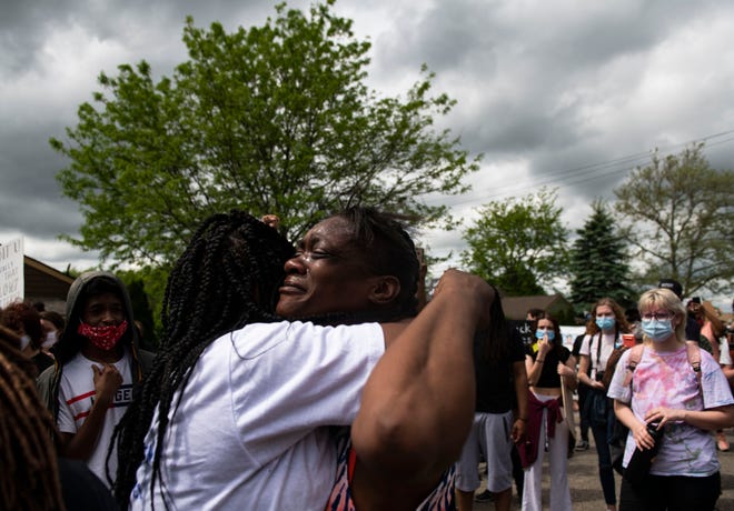 A family member of Sha'Teina Grady El begins to weep and is comforted during a protest for Sha'Teina Grady El, an Ypsilanti woman who was punched repeatedly in the head by a Washtenaw County Sheriff's deputy last weekend, Thursday May 28, 2020, in Ann Arbor, Mich.