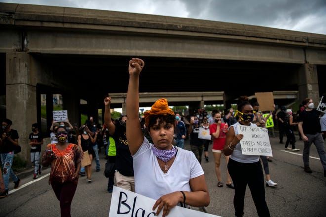 Protesters march underneath U.S. 23 and cross into Ann Arbor, Mich., during a protest Thursday, May 28, 2020, for Sha'Teina Grady El, an Ypsilanti woman who was punched repeatedly in the head by a Washtenaw County Sheriff's deputy last weekend.