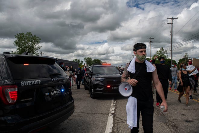 Protesters march in the streets towards U.S. 23 and cross into Ann Arbor during a protest for Sha'Teina Grady El, an Ypsilanti woman who was punched repeatedly in the head by a Washtenaw County Sheriff's deputy last weekend, Thursday, May 28, 2020 in Ann Arbor, Mich.