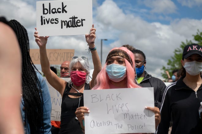 Protesters march in the streets towards U.S. 23 and cross into Ann Arbor during a protest for Sha'Teina Grady El, an Ypsilanti woman who was punched repeatedly in the head by a Washtenaw County Sheriff's deputy last weekend, Thursday May 28, 2020, in Ann Arbor, Mich.