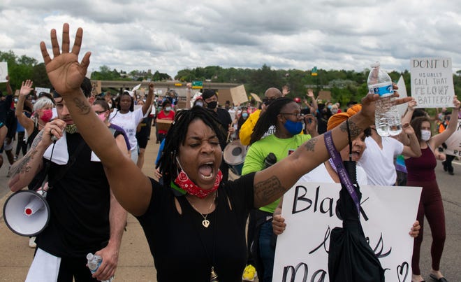 Protesters march in the streets towards U.S. 23 and cross into Ann Arbor, Mich., Thursday, May 28, 2020, during a protest for Sha'Teina Grady El, an Ypsilanti woman who was punched repeatedly in the head by a Washtenaw County Sheriff's deputy last weekend.
