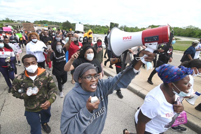 Sha'Teina Grady El,  who was punched repeatedly by a Washtenaw County Sheriffs Deputy, chants and marches with hundreds of supporters as they shut down Washtenaw Avenue in Ann Arbor on Friday, May 29, 2020 for their protest.