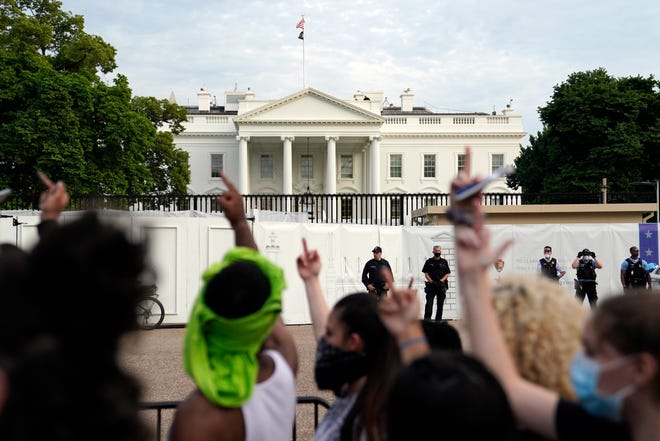 Demonstrators gather across from the White House to protest the death of George Floyd, a black man who died in police custody in Minneapolis, Friday, May 29, 2020, in Washington.