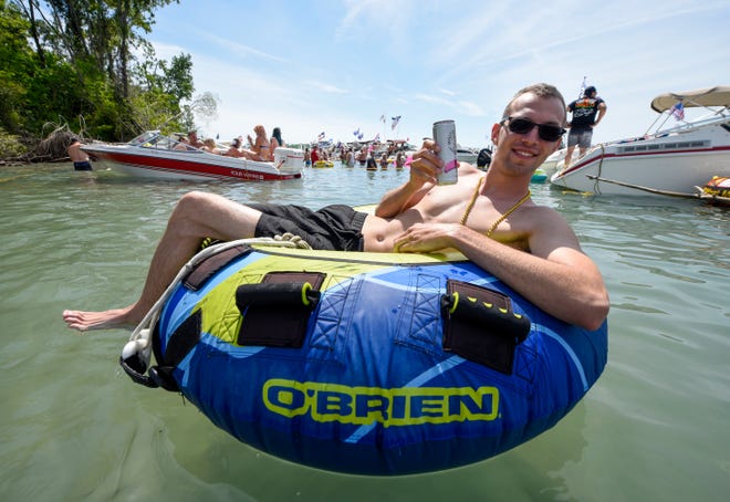Kyle Janulis, Macomb Township, enjoys a float and a drink during the annual Jobbie Nooner at Gull Island on Lake St. Clair, Friday, June 26, 2020. Kyle janulis, Macomb township.