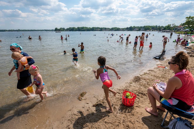 People enjoy a day of warm weather at Mercer Beach, in Walled Lake, June 30, 2020.