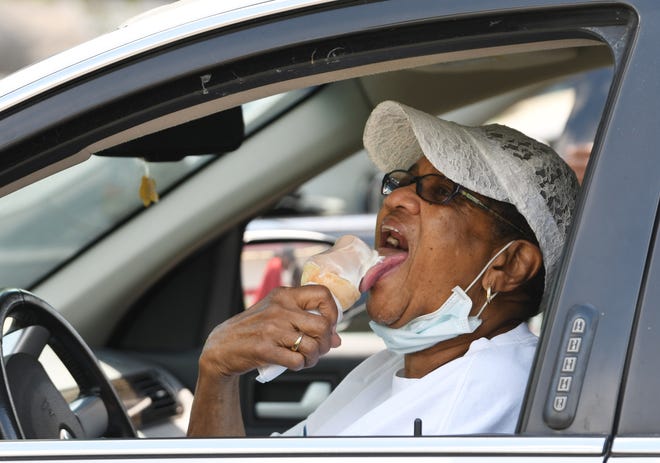 Ernestine Milliean, 86, of Detroit, enjoys her chocolate and vanilla ice cream cone in the parking lot of the Dairy Queen in Ferndale, June 30, 2020.