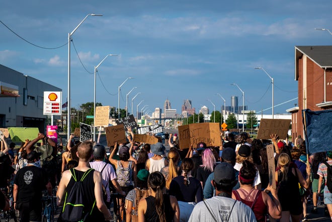 Protesters march back toward the Detroit Police Department's 4th Precinct in Detroit on June 30, 2020.
