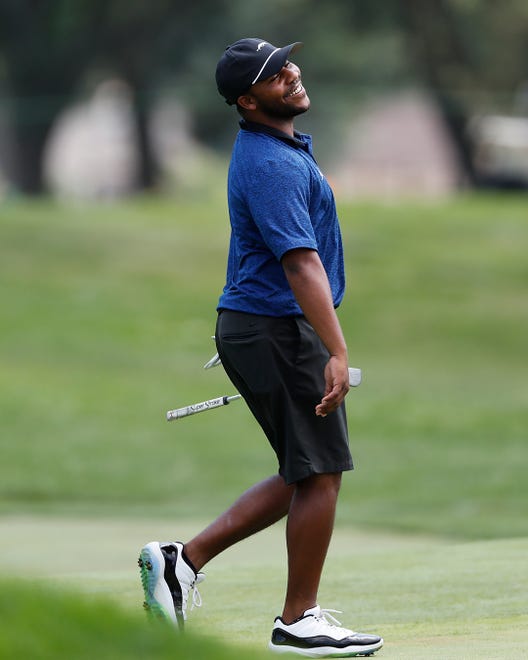 Harold Varner III reacts after a shot on the 17th green during a nine-hole exhibition.