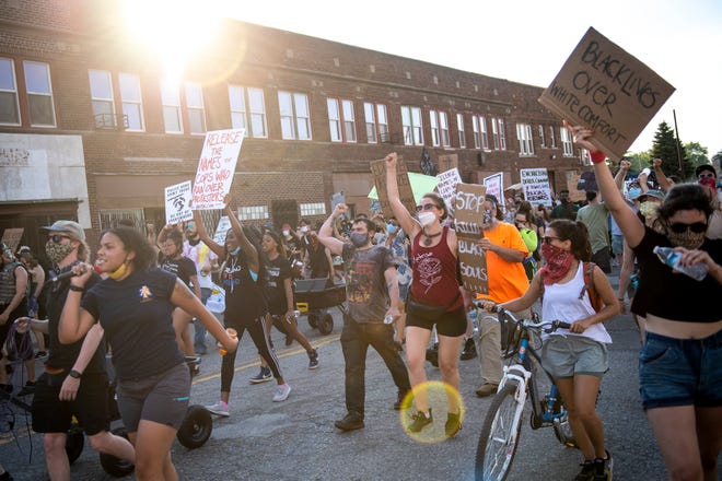 Protesters march back toward the Detroit Police Department's 4th Precinct in Detroit on June 30, 2020.