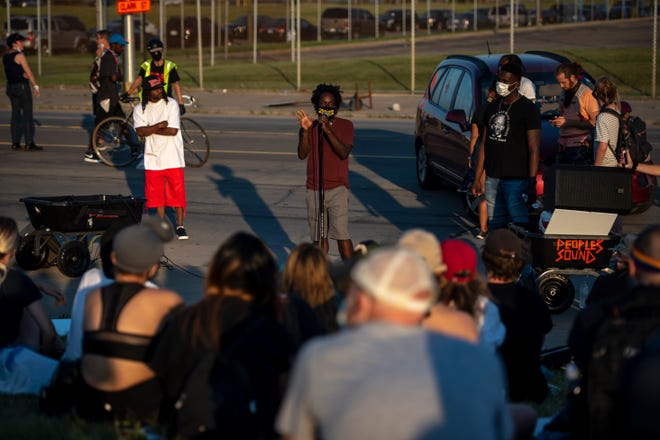 Activist Tristan Taylor speaks to protesters gathered outside of the Detroit Police Department's 4th Precinct in Detroit on June 30, 2020.