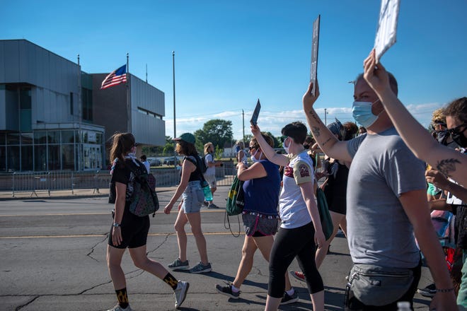 Protesters march outside of the Detroit Police Department's 4th Precinct in Detroit on June 30, 2020.