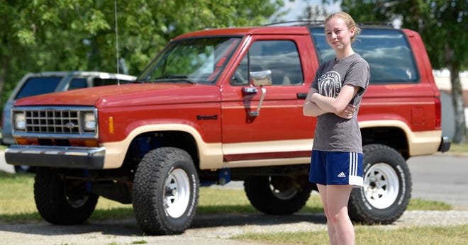 Merry Parks, 20, poses in front of her 1986 Ford Bronco II.