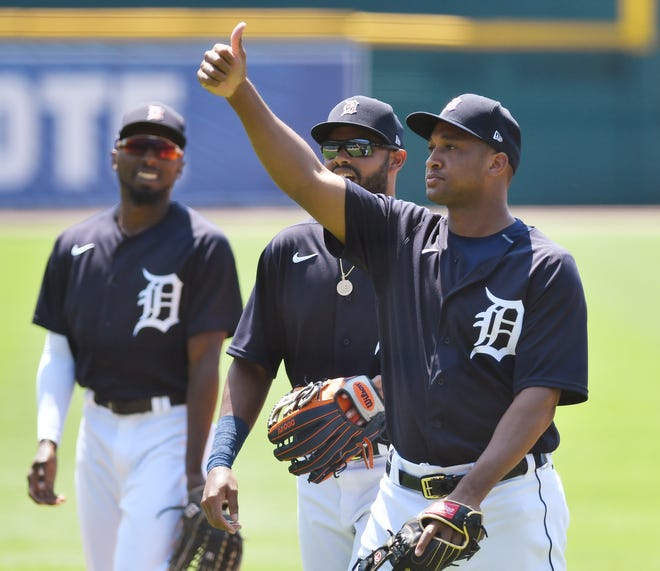 Tigers second baseman Jonathan Schoop appears to pretend to toss a ball to non-existent fans and then give a thumbs up during an intrasquad game. Detroit Tigers Summer Camp work out at Comerica Park in Detroit on July 9, 2020.