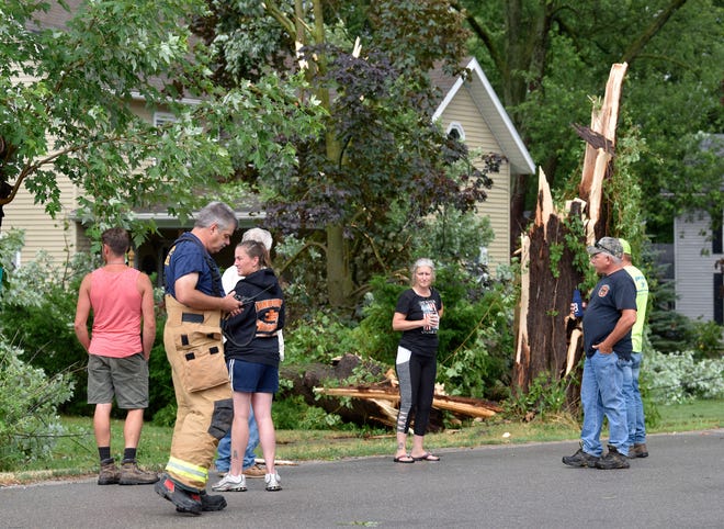 Berlin Twp. fire fighter Tom Callewaert secures the scene on Hough Rd., just east of North Ave. in Berville.
Residents on Hough Rd., just east of North Ave. in Berville, southwestern St. Clair County, deal with downed trees into houses and vehicles, Friday afternoon, July 10, 2020, after hail and straight-line winds blew through the area early Friday afternoon.