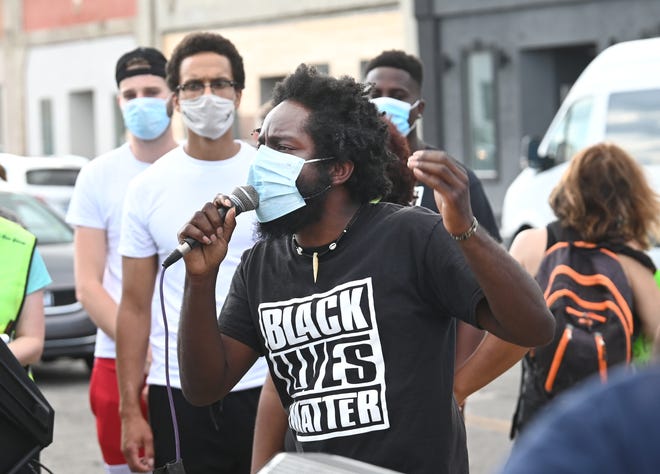 Organizer Tristan Taylor speaks with conviction to a crowd gathered at the intersection of McNichols Road and San Juan Road in Detroit on Saturday, July 11, 2020.