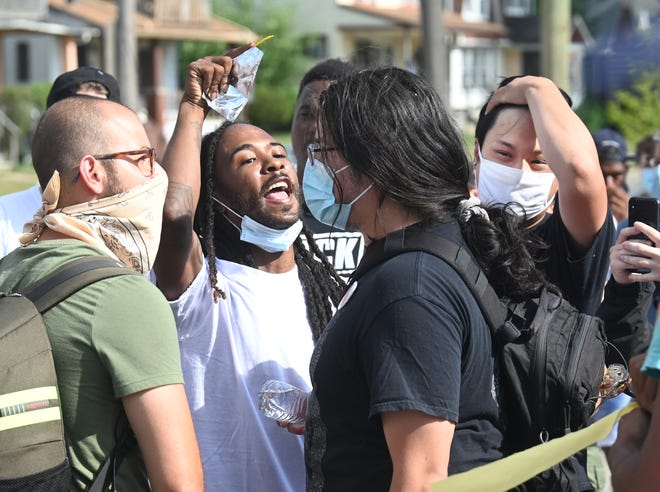 Protesters face off during a brief altercation at the intersection of NcNichols Road and San Juan Road in Detroit on Saturday, July 11, 2020.