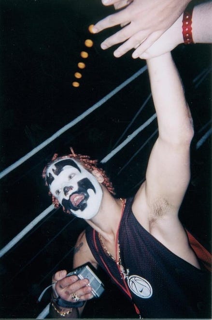 Shaggy 2 Dope of the Insane Clown Posse slaps hands with fans at the first Gathering of the Juggalos festival.