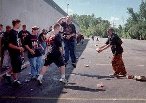 A Juggalo prepares to punt a 2-liter of Faygo in the parking lot at the first Gathering of the Juggalos festival.