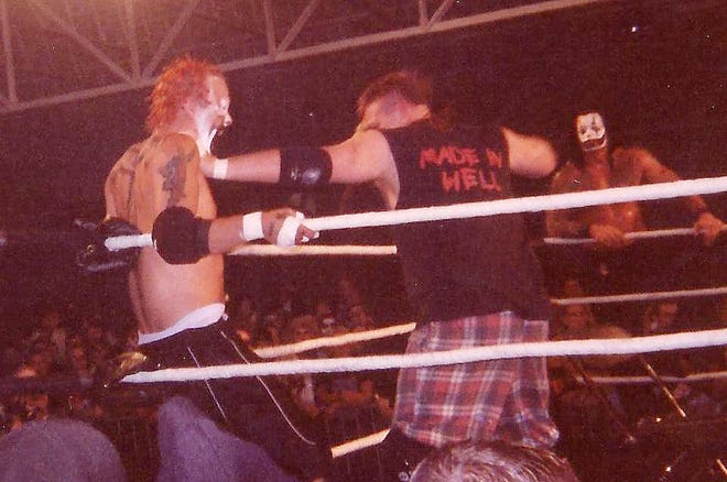 Shaggy 2 Dope takes a beating while Vampiro looks on at the first Gathering of the Juggalos festival at the Novi Expo Center.