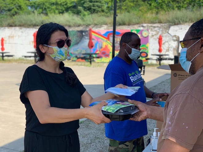 Amid the pandemic, U.S. Rep. Rashida Tlaib, D-Detroit, has resumed in-person campaigning and knocking doors in her bid for a second term, here at a food distribution event at Piquette Square in Detroit.