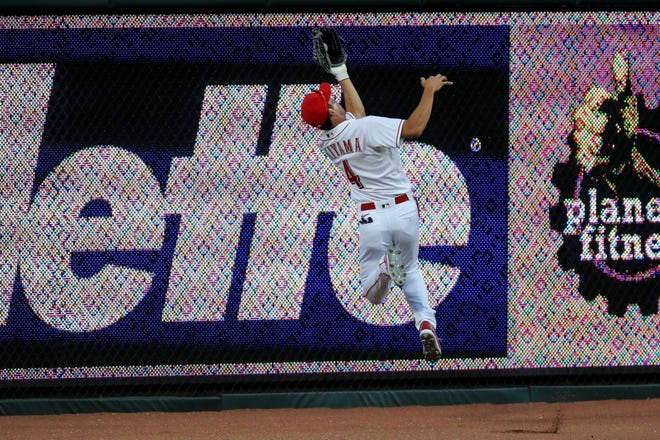 Cincinnati Reds' Shogo Akiyama (4) leaps to grab a ball hit by Detroit Tigers' Harold Castro (30) in the eighth inning.