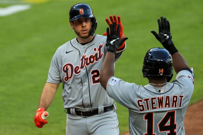 Detroit Tigers' C.J. Cron (26) celebrates with Christin Stewart (14) after hitting a solo home run in the fourth inning of a baseball game against the Cincinnati Reds at Great American Ballpark in Cincinnati, Friday, July 24, 2020.