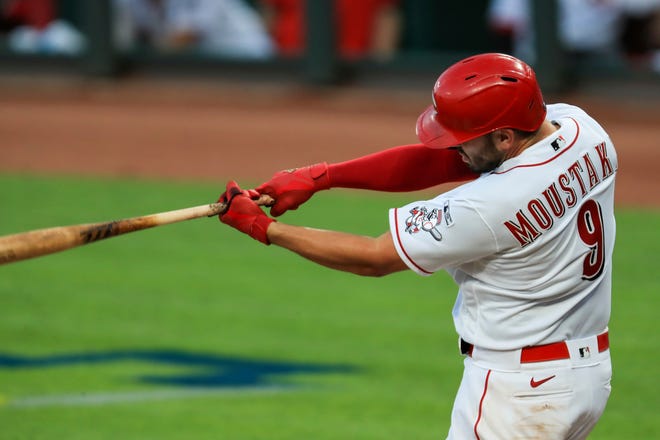Cincinnati Reds' Mike Moustakas (9) hits a two-run home run in the seventh inning.