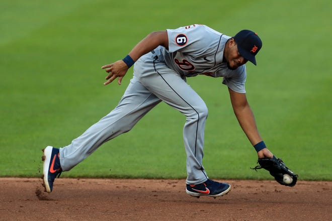 Detroit Tigers' Jeimer Candelario fields the ball before throwing out Cincinnati Reds' Eugenio Suarez in the third inning during a baseball game at Great American Ballpark in Cincinnati, Friday, July 24, 2020.