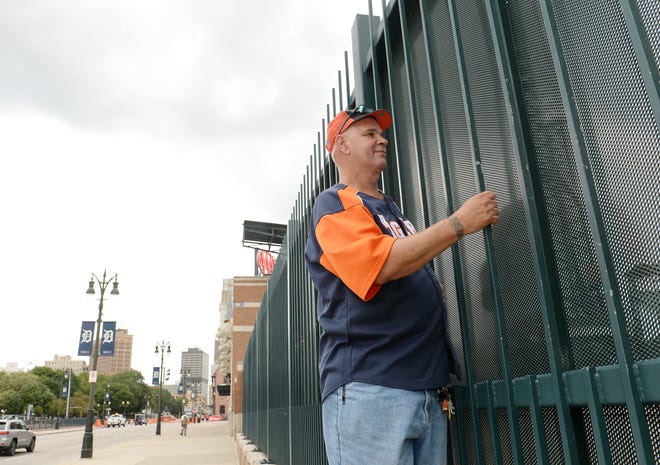 David Willis, 60, of Detroit, watches the pregame players warm up from the center-field fence of Comerica Park as Tigers fans prepare for home opener at Comerica Park in downtown Detroit, Monday, July 27, 2020. Willis said he has been doing this for the last 10 years from the same spot