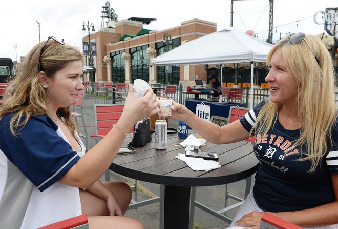 Lindsay Stanek, 22, of Detroit and her mom Kathy Stanek, 53, of Annapolis, Md., celebrate home opener with a toast of tequila at the Tin Roof bar.
