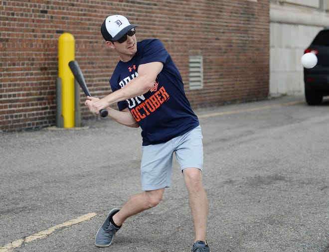 Andrew Anderlie, 33, of Oxford, plays Wiffle ball in a parking lot prior to the Tigers home opener at Comerica Park. This is Anderlie ' s 27th home opener.