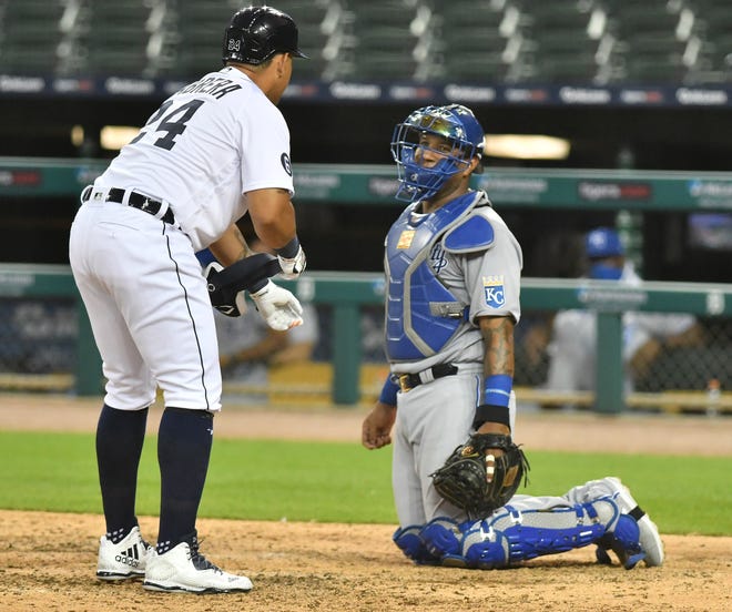 Tigers' Miguel Cabrera chats with Royals catcher Salvador Perez before heading to first on a walk during Monday's game.