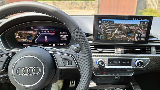 The driver-focused cockpit of the 2020 Audi S5 Sportback is full of electronic gadgetry including a digital dash, colorful center screen and steering wheel with the latest cruise control buttons.