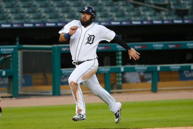 Detroit Tigers' Austin Romine runs home to score in the sixth inning of a baseball game against the Cincinnati Reds in Detroit, Friday, July 31, 2020. (AP Photo/Paul Sancya)