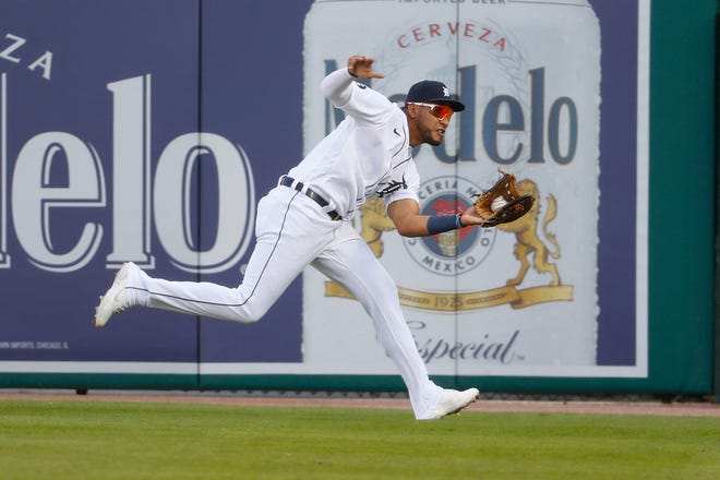 Detroit Tigers right fielder Victor Reyes catches a Cincinnati Reds' Nicholas Castellanos fly ball on the run in the second inning of a baseball game in Detroit, Friday, July 31, 2020. (AP Photo/Paul Sancya)