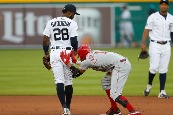 Cincinnati Reds' Nicholas Castellanos rubs his hands on Detroit Tigers' Niko Goodrum (28) after hitting a double in the fifth inning of a baseball game in Detroit, Friday, July 31, 2020. (AP Photo/Paul Sancya)