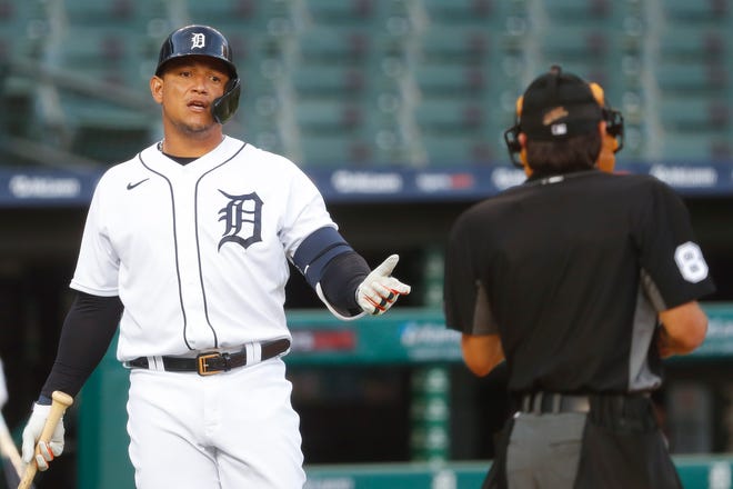 Detroit Tigers' Miguel Cabrera talks with home plate umpire David Rackley after striking out against the Cincinnati Reds in the fourth inning of a baseball game in Detroit, Friday, July 31, 2020. (AP Photo/Paul Sancya)