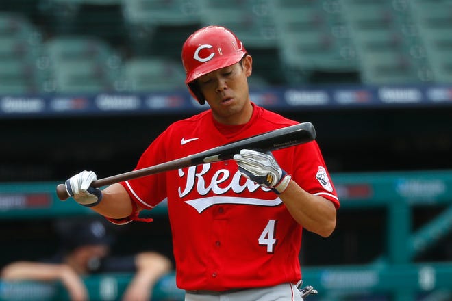 Reds hitter Shogo Akiyama checks his bat in the second inning of the first game of a doubleheader.
