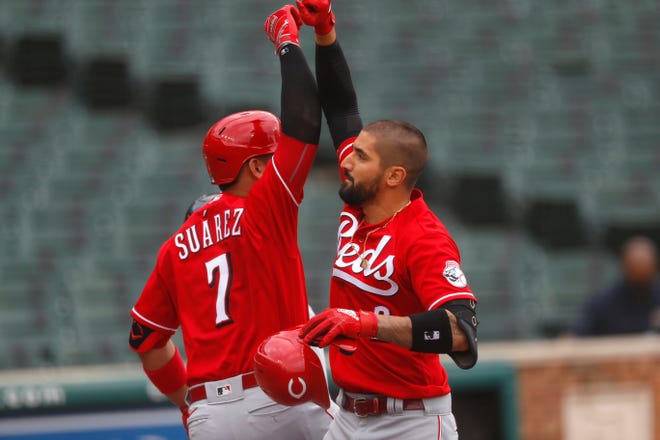 The Reds' Nick Castellanos, right, celebrates his solo home run with teammate Eugenio Suarez (7) in the third inning of the first game of a doubleheader.