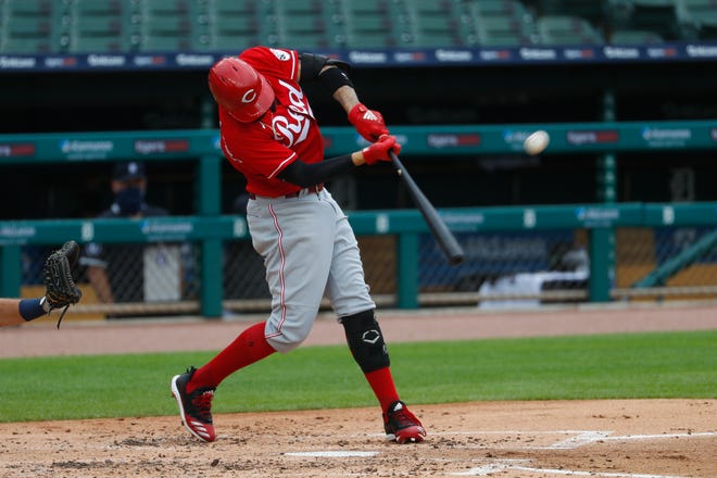 The Reds' Nick Castellanos hits a solo home run against the Tigers in the third inning of the first game of a doubleheader.